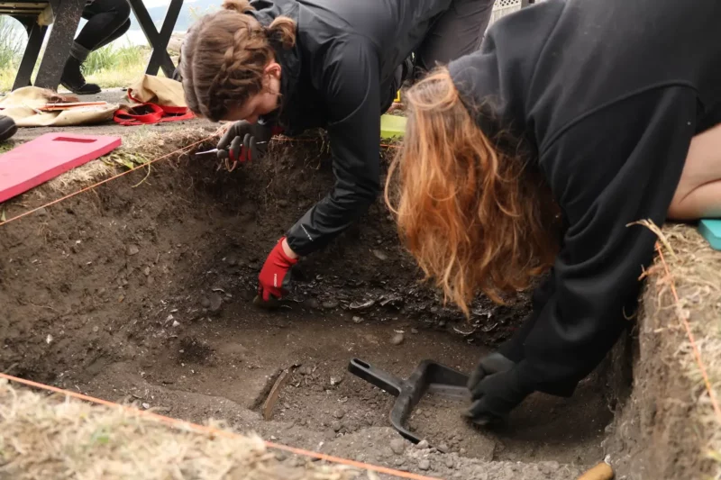 University of Victoria students Morgan Holder and Tika Gilbank uncovering ancient cooking feature